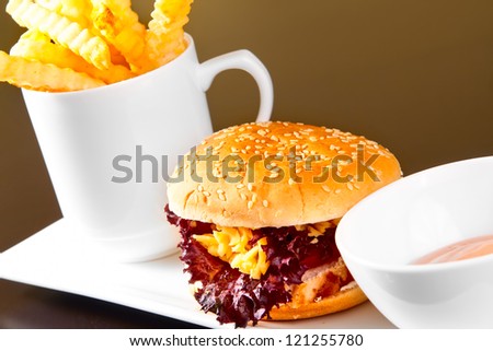 Hamburger with fries on white plate