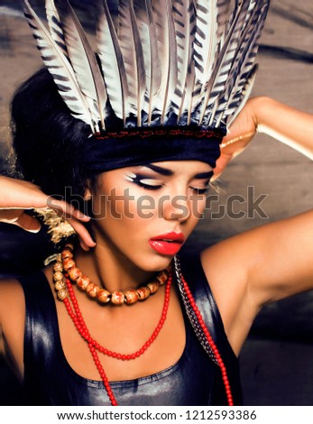 young pretty woman with make up like red indian