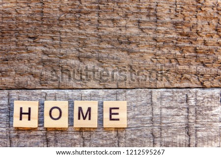 Inscription HOME letters word on old wooden backdrop. Eco Village, abstract environmental background. Real estate mortgage property insurance sweet home ecology concept. Flat lay top view copy cpace