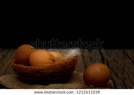 Still life-Eggs on nest arranged in a black scene, Food concept. Dark tone picture.