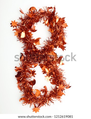 Red christmas tinsel with stars as number 8,on a white background