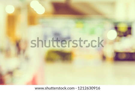 Vintage tone Abstract blur image of shopping mall or exhibition hall with bokeh for background usage .