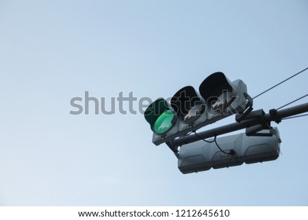 Green traffic light ,isolated on sky background