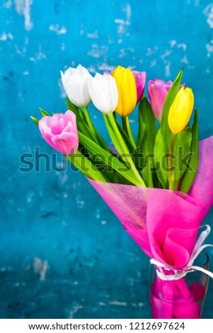 Colorful Tulips on soft blue background. Card background with copy spase