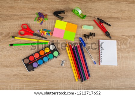 Close up picture of colored school supplies - Scissors, marker, pencils, gouache, etc.