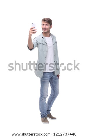 in full growth.young man taking selfie