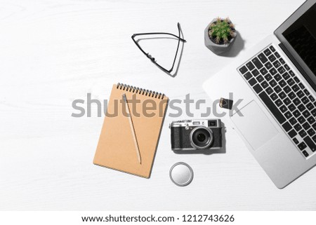 Flat lay composition with equipment for professional photographer on wooden background. Space for text