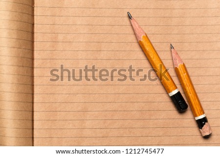 Pencils and notepad paper sheets on gray desk table