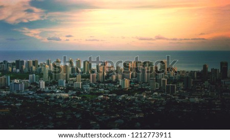 Cityscape of Honolulu city and Waikiki beach and ocean in town with sunset sky at evening and twilight from Tantalus lookout mountain in Oahu Island, Hawaii USA