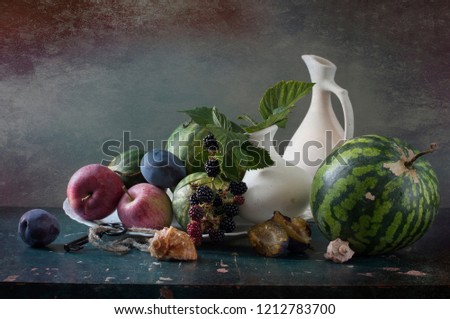 vegetarian autumn still life with fruits and vegetables on a colored background