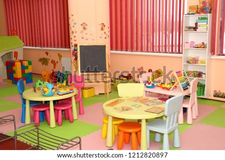 Interior of modern kids playing room in the kindergarten - children's entertainment, recreation, sports, educational games indoor Royalty-Free Stock Photo #1212820897