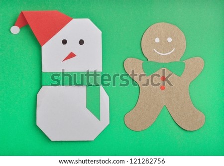 paper cut out of Christmas snow man under green background