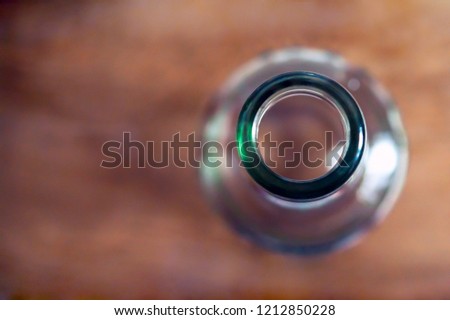 Top View Of A Bottleneck, Empty Bottle On A Wooden Table. Healthy Living And Detox Concept. Abstinence, Alcoholism Treatment. New Year’s Resolutions. Becoming A New You, Promising A Better Life. Royalty-Free Stock Photo #1212850228