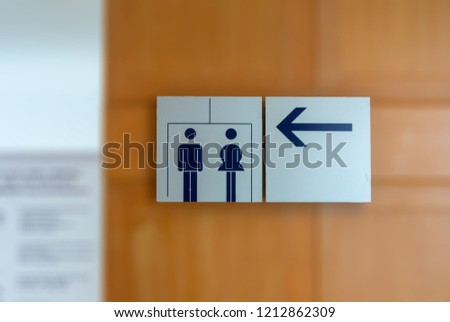 Signs to the bathroom. Background Blurred.
