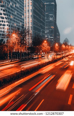 Traffic on the busy urban expressway at night in Beijing International Trade and Finance Center, China, and the trajectory of cars.