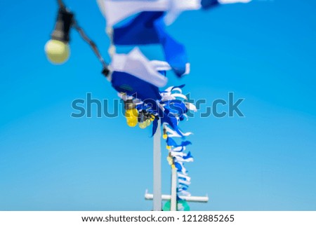 boat mast with white and blue decorations .