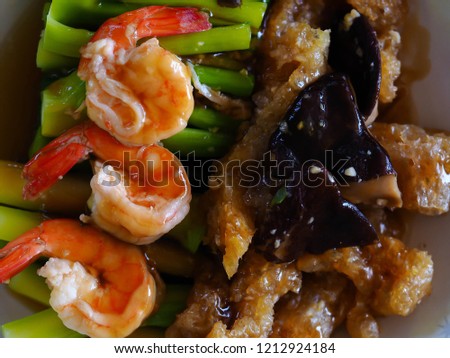 Stir fried Chinese Hong Kong kale, shrimp, fish maw and mushroom in oyster sauce. Chinese food.