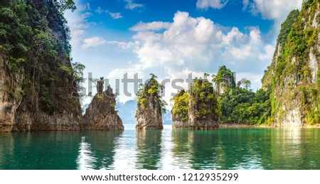 Panorama of Limenstone rocks at Cheow Lan lake, Ratchaprapha Dam, Khao Sok National Park in Thailand in a summer day Royalty-Free Stock Photo #1212935299
