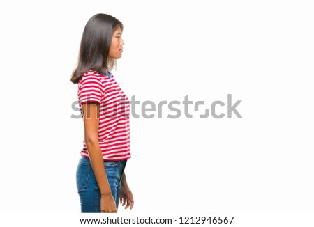 Young asian woman over isolated background looking to side, relax profile pose with natural face with confident smile.
