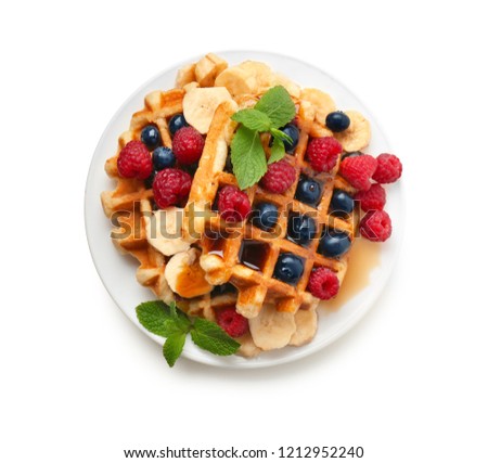 Plate with tasty waffles, fruit and berries on white background Royalty-Free Stock Photo #1212952240