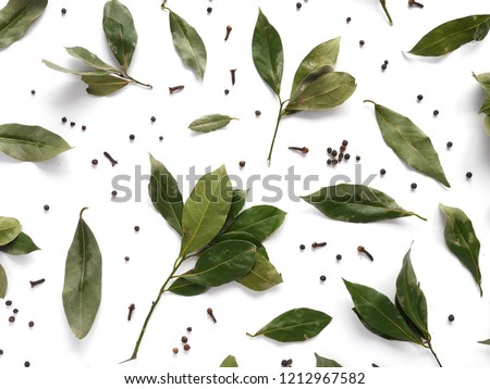 dry bay leaves and black pepper flat lay, top view. Spice pattern Royalty-Free Stock Photo #1212967582