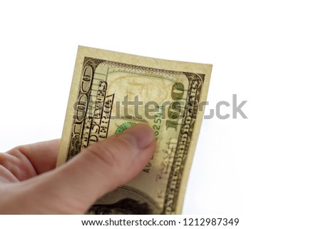 Authentication of banknote 100 dollars for clearance. Watermarks on a 100-dollar bill. Banknote in hand on a white background with a watermark. Royalty-Free Stock Photo #1212987349