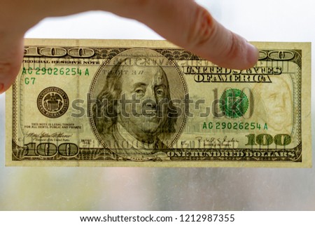 Authentication of banknote 100 dollars for clearance. Watermarks on a 100-dollar bill.