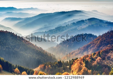 Scenic mountain landscape. View on the Black Forest, Germany, covered in fog. Colorful travel background. Royalty-Free Stock Photo #1212988969