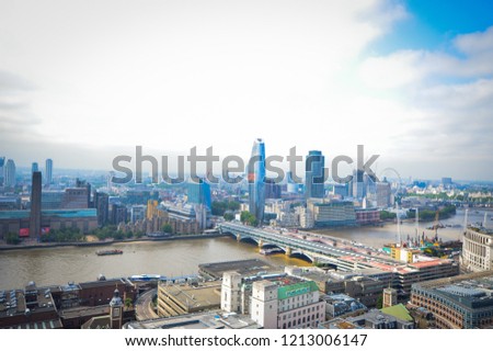 Top view from St. Paul's Cathedral on London, skyscrapers, River Thames and buildings on the background of blue sky