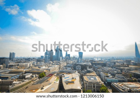 Top view from St. Paul's Cathedral on London, skyscrapers, River Thames and buildings on the background of blue sky