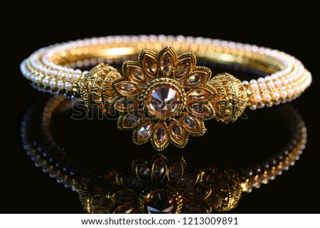 Fancy designer Golden bracelet for woman fashion/ Gold plated jewelry closeup image on black background   