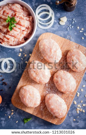 Raw cutlets from minced chicken and pork with the addition of oat flakes, top view, selective focus