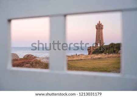 view to lighthouse through frame of white border in the morning in France 