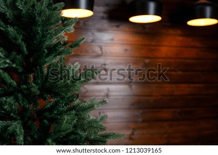 Christmas or New Year background: lamps, green cristmas tee, sofa, ladder, wooden wall, Santa Claus