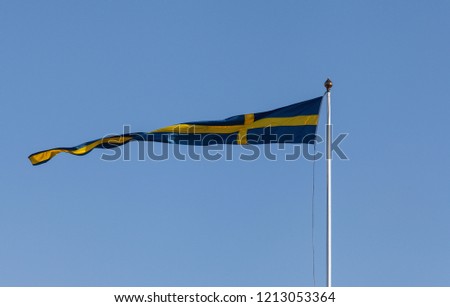Sweden, Swedish pennant, blue sky. Windy day.