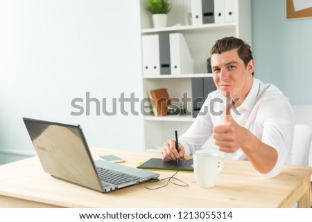Business, humor and people concept - Young graphic designer man in white shirt gesture thumb up