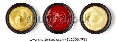 Bowls of ketchup mayonnaise and mustard isolated on white background, top view Royalty-Free Stock Photo #1213057933