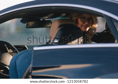 Image of woman in sunglasses in car