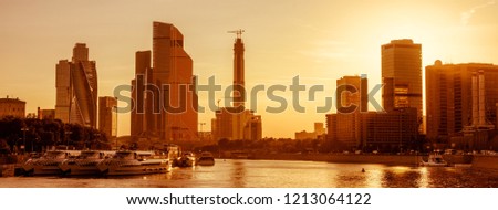 Panoramic view of Moscow at sunset, Russia. Sunny Moscow cityscape with Moskva River in summer. Modern skyscrapers on Moscow waterfront. Skyline, scenery of Moscow city buildings in evening sun light