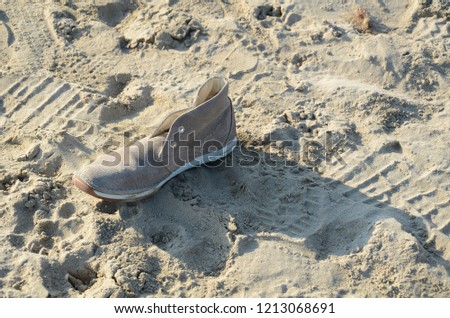 lonely shoe on the sand