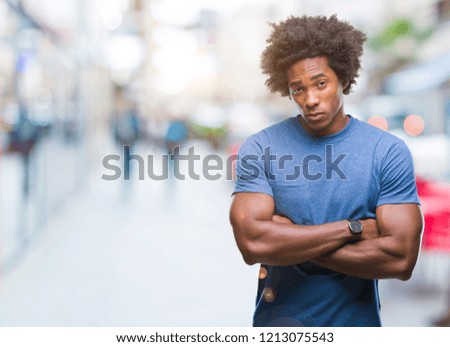 Afro american man over isolated background skeptic and nervous, disapproving expression on face with crossed arms. Negative person.