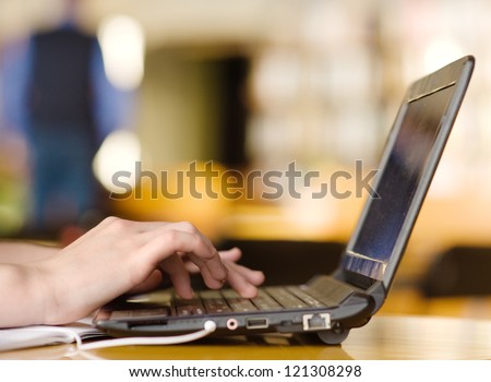 Hands typing on notebook in college class Royalty-Free Stock Photo #121308298