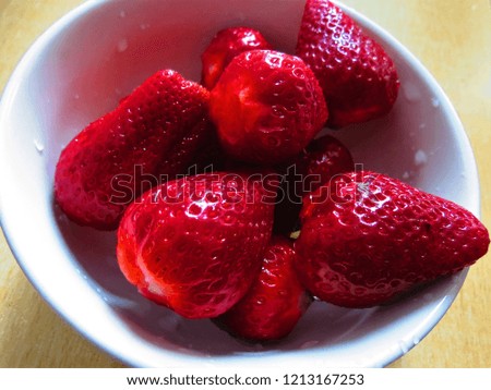Fresh strawberries in white bowl. Berries background. 