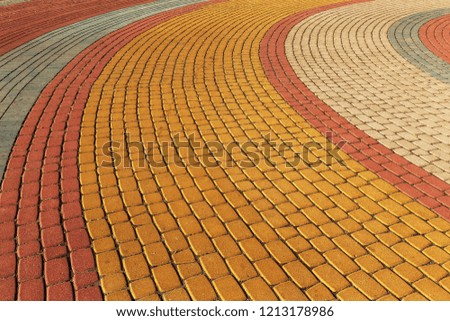 Modern cement multi-colored paving slabs. The background of a beautiful pedestrian walkway from modern fashionable paving tiles as a staged background for a perspective design