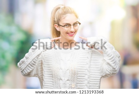 Young beautiful blonde woman wearing glasses over isolated background smiling confident showing and pointing with fingers teeth and mouth. Health concept.
