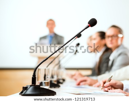 close-up of a microphone, a speaker at the conference Royalty-Free Stock Photo #121319713