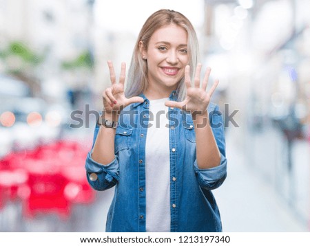 Young blonde woman over isolated background showing and pointing up with fingers number eight while smiling confident and happy.
