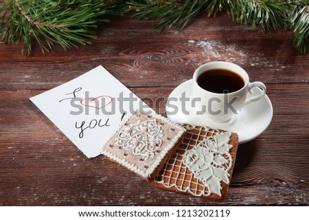 Ginger cookies and a Cup of coffee on a wooden background. Manual work. Wishes of love in the New year and Valentine's day.