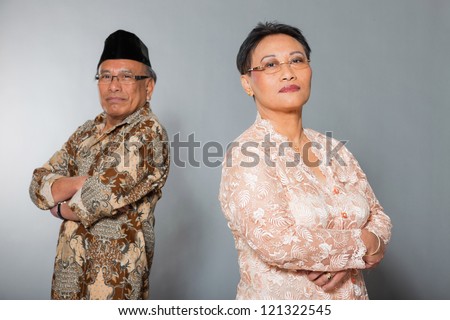 Senior indonesian couple in love. Traditional clothing. Studio shot.
