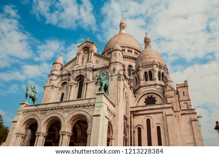 An amazing view of the basilica of Sacre Coeur in a day with a blue sky with clouds. Symbol of the Montmartre district. Paris, France